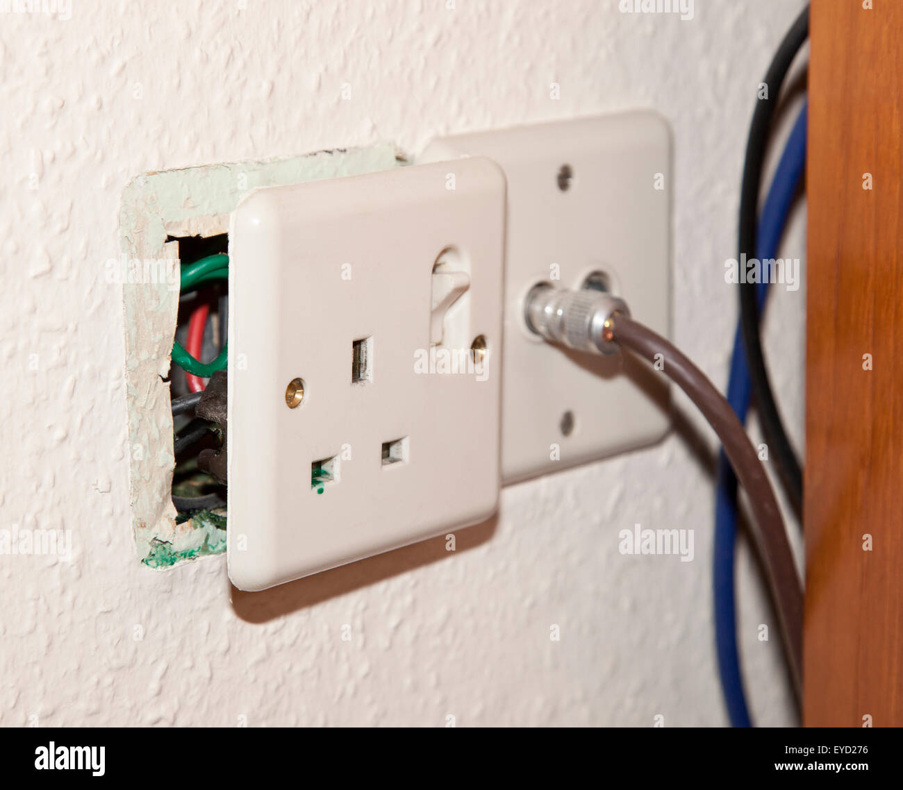 An electrical socket showing the problem of Di-osoctyl Pathalate in the UK, causing a green discharge Stock Photo