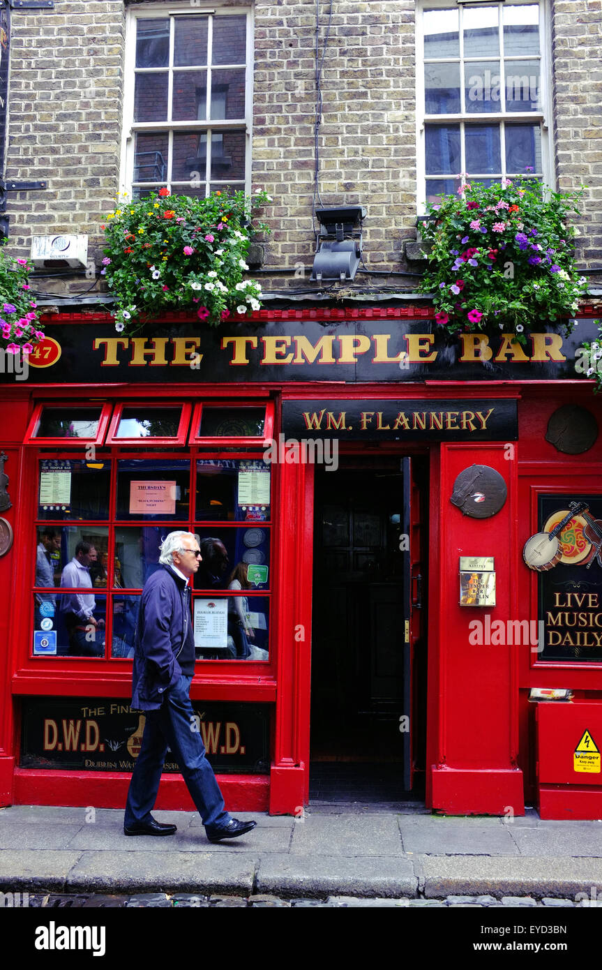 A man walks past The Temple Bar pub in the Temple Bar area of Dublin. Stock Photo