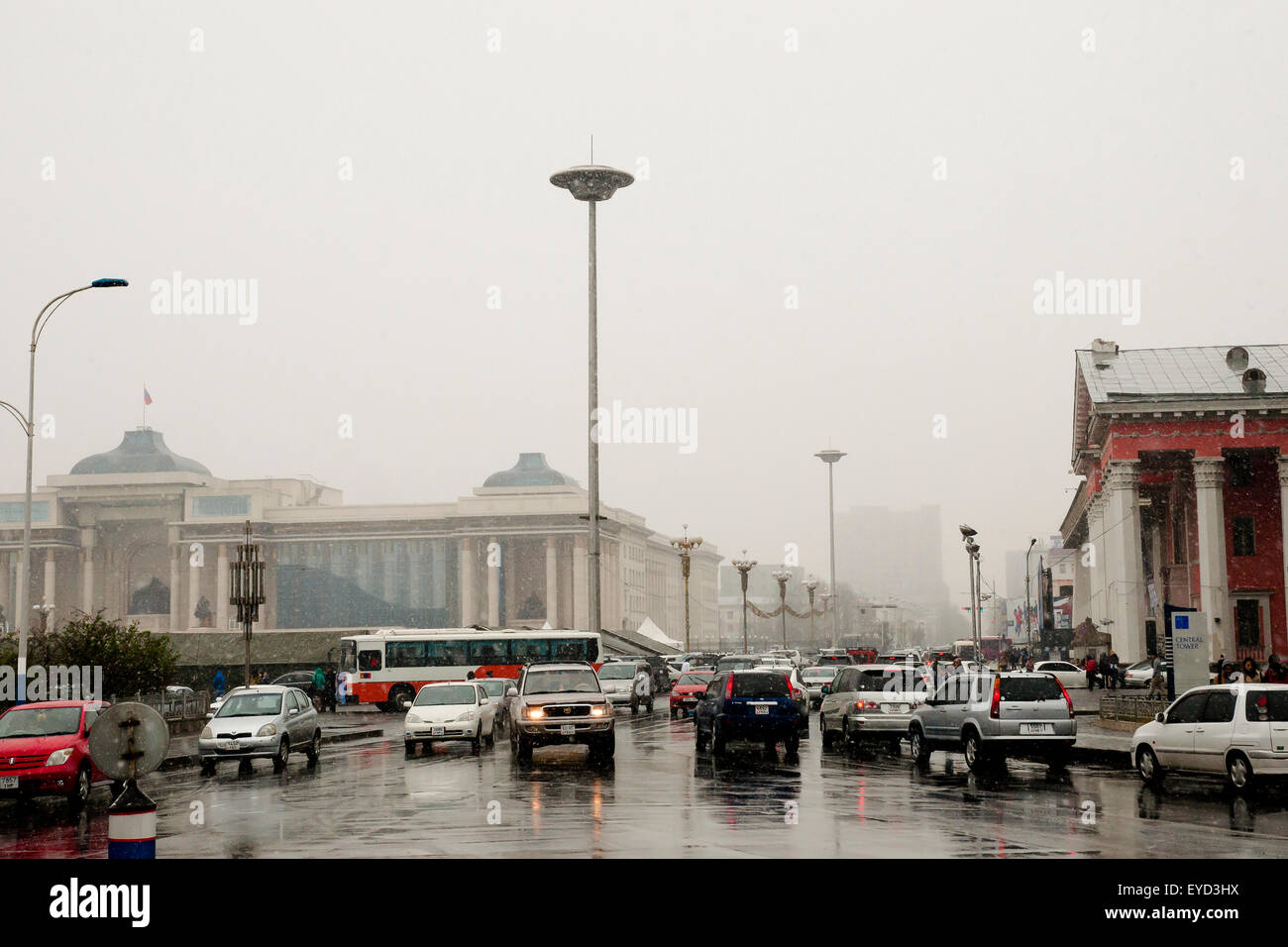 Daily traffic on Olympic Street on a snowy day in the capital city - Ulaanbaatar - Mongolia Stock Photo
