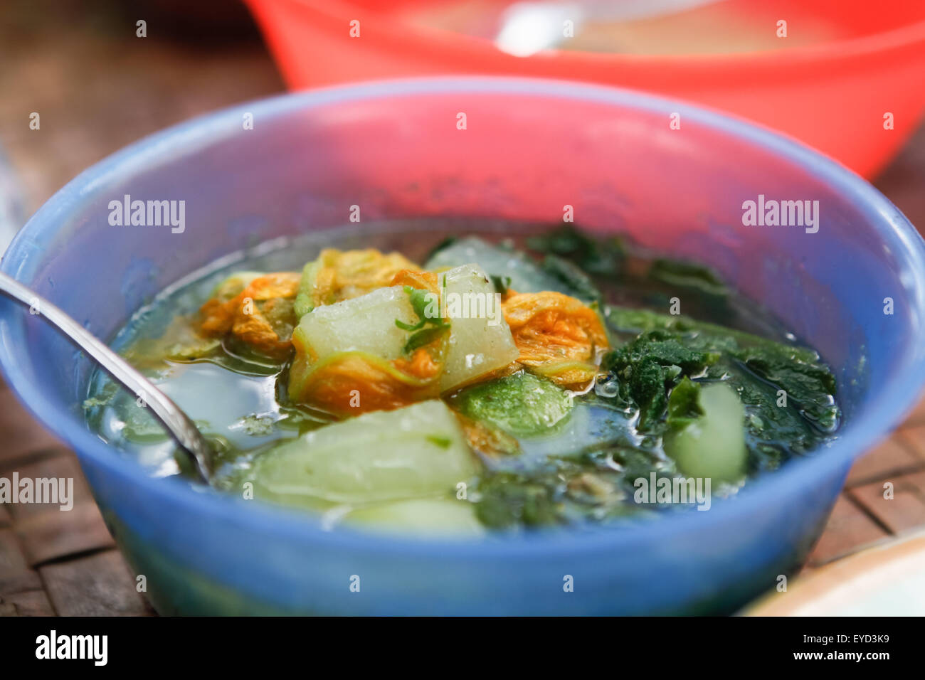 Close up view of a wooden table with a fresh, ready-to-eat homemade  vegetable soup. Stock Photo by lucigerma