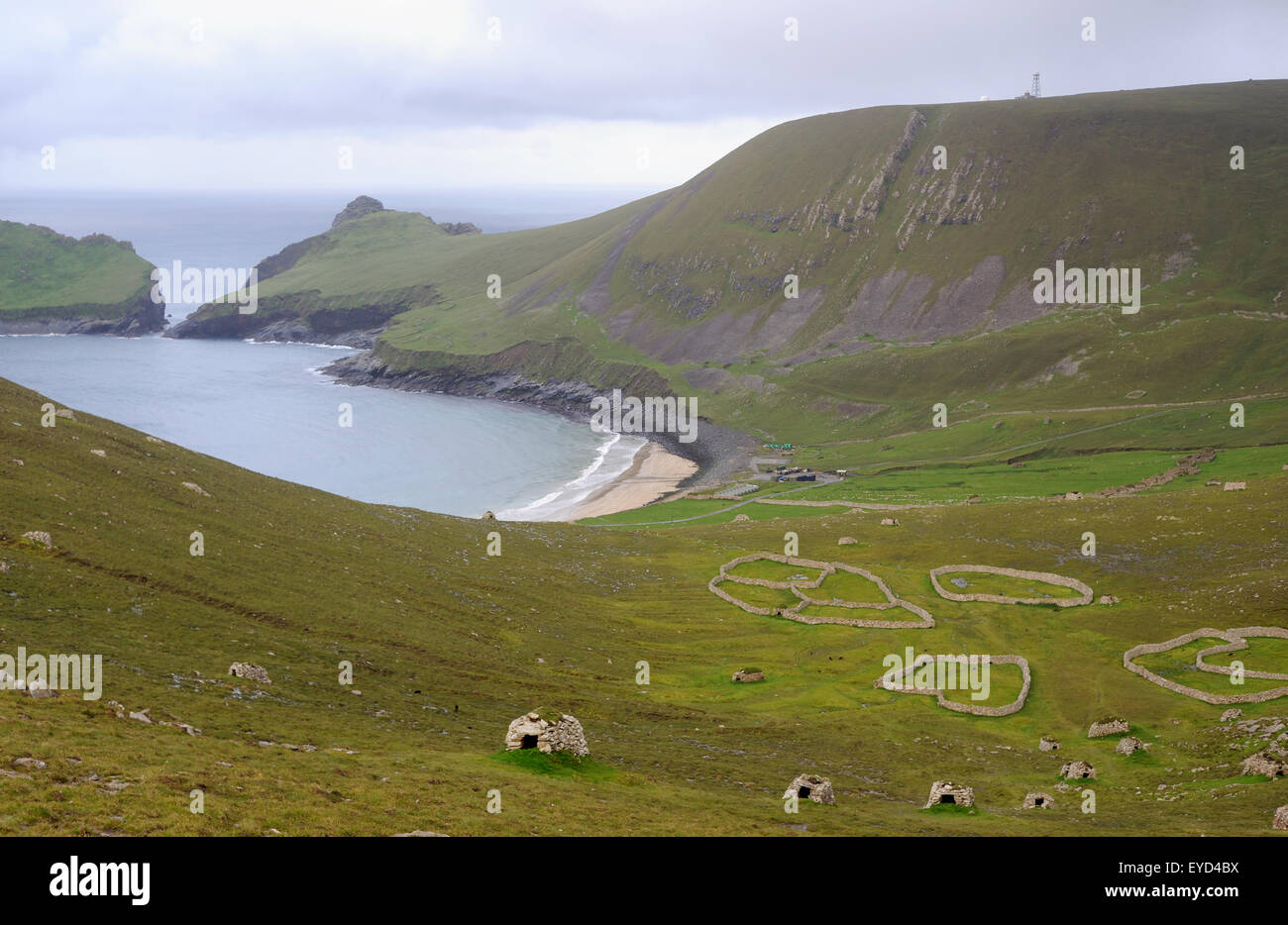 Cleits, stone storage buildings, and stone enclosures on the hillside above Village Bay.  The island of Dun is on the left. Stock Photo