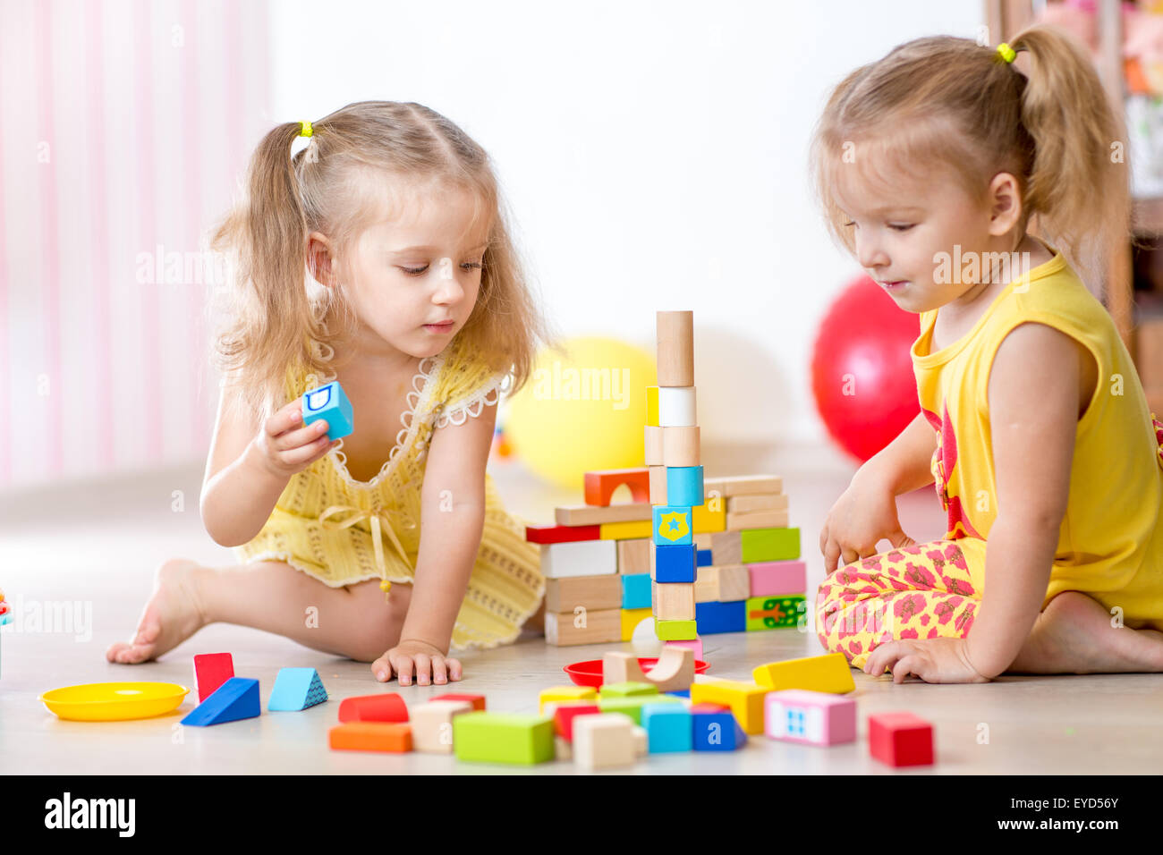 children playing wooden toys at home Stock Photo