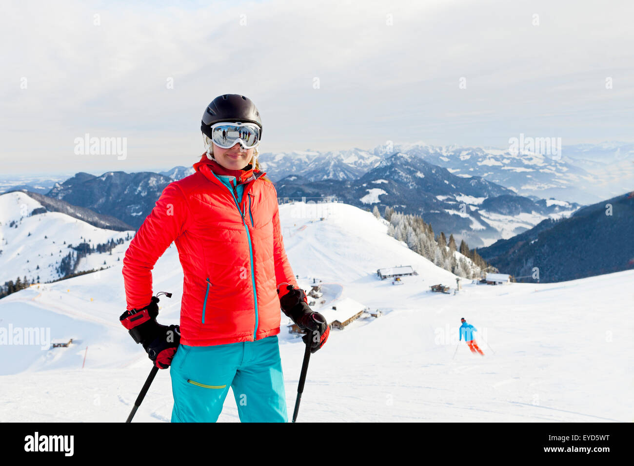 Ski holiday, Woman against snowcapped mountain, Sudelfeld, Bavaria, Germany Stock Photo