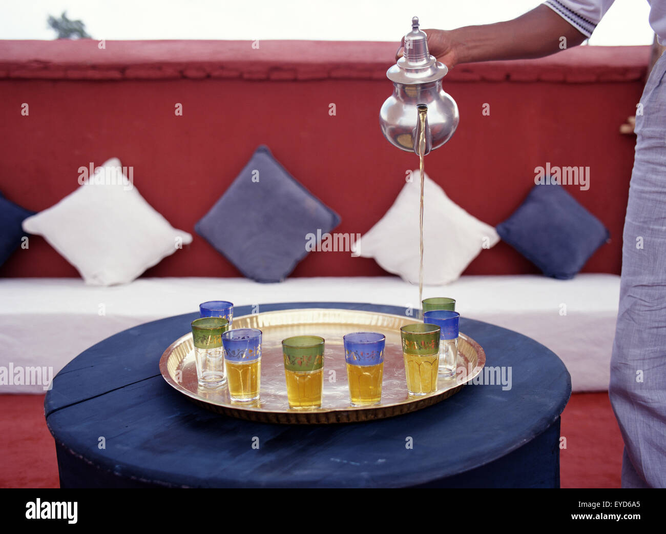 A Server Pouring Tea From A Silver Teapot Stock Photo Alamy