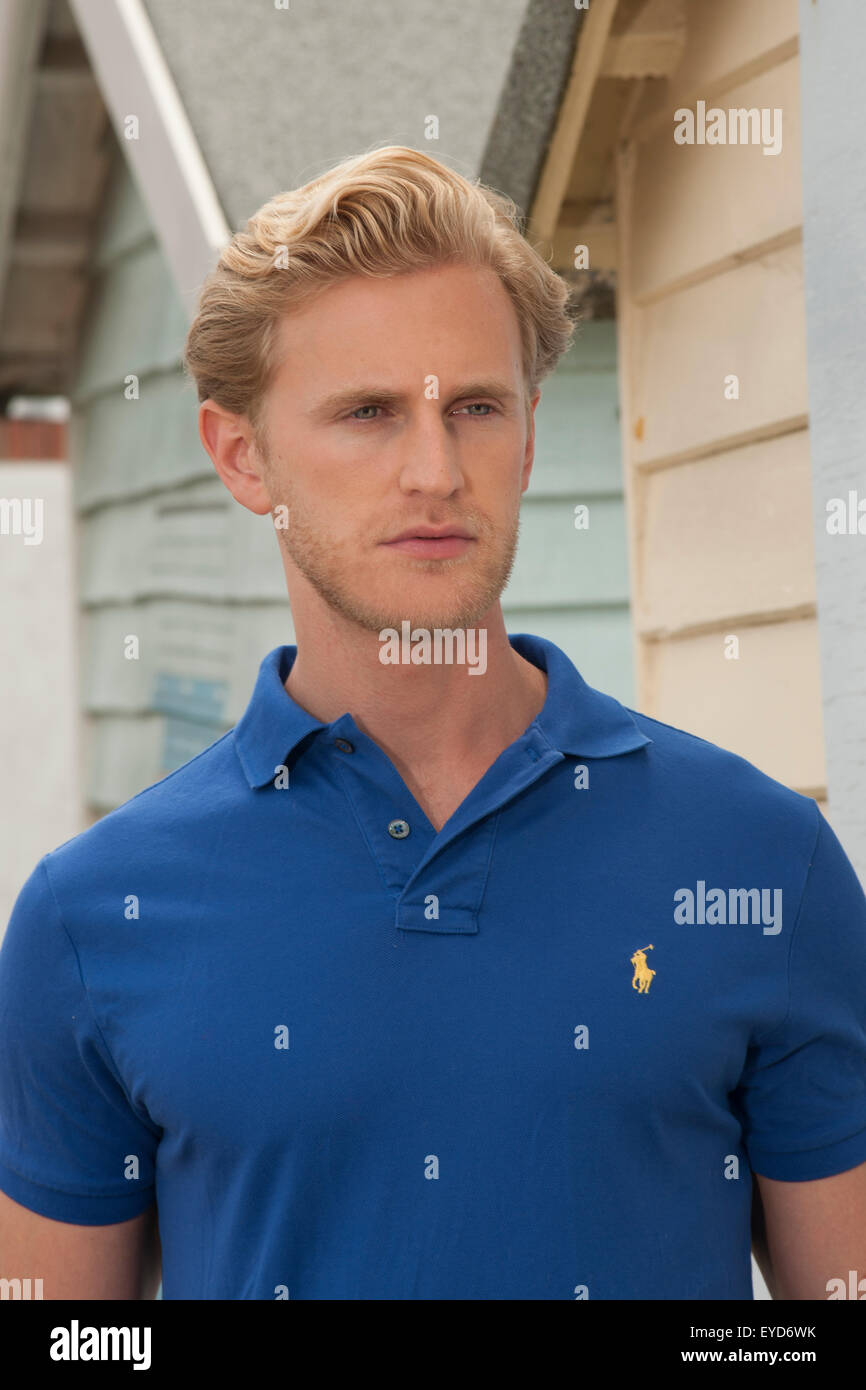 headshot of a blonde man with stubble wearing a blue polo shirt Stock Photo  - Alamy