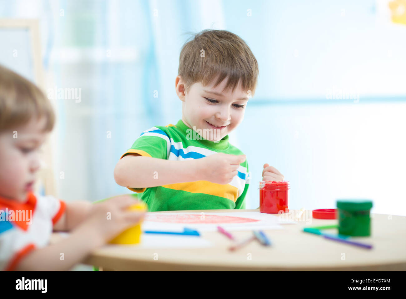 children painting in daycare or nursery or playschool Stock Photo