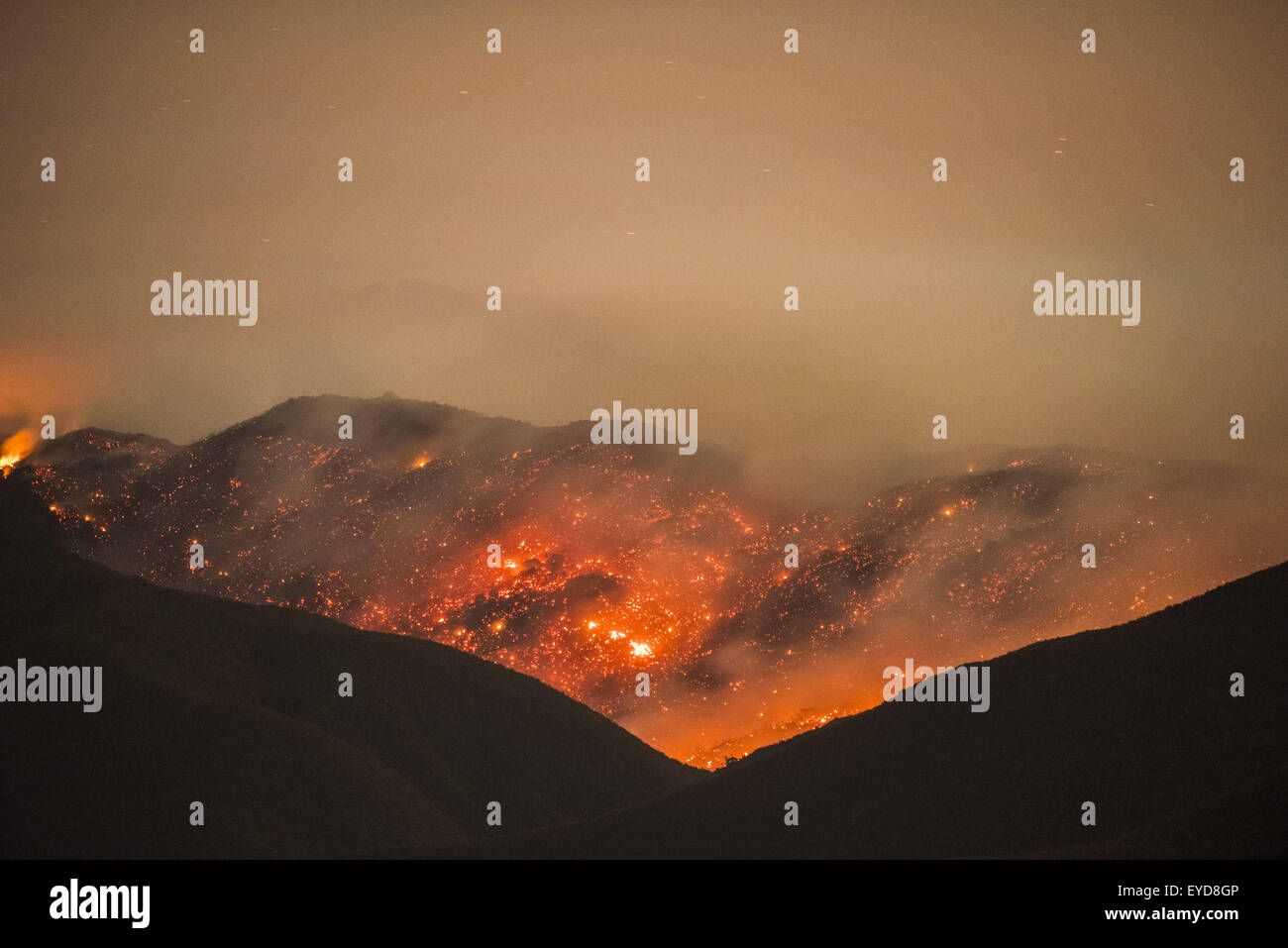 Aguanga, CA, USA. 24th July, 2015. The Cutca Fire burns at night in the Cleveland National Forest on Palomar Mountain Friday Night July 24, 2015. The fire was estimated at 200 acres and was 0% contained. The fire is burning in heavy fuels in remote terrain and crews were being flown in to battle the blaze overnight. The cause of the fire is suspected to be a holdover lightning strike that ignited. © Stuart Palley/ZUMA Wire/Alamy Live News Stock Photo