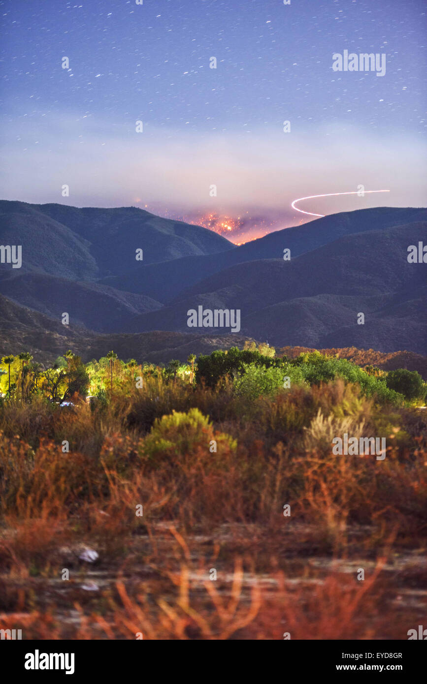 Aguanga, CA, USA. 24th July, 2015. The Cutca Fire burns at night in the Cleveland National Forest on Palomar Mountain Friday Night July 24, 2015. The fire was estimated at 200 acres and was 0% contained. The fire is burning in heavy fuels in remote terrain and crews were being flown in to battle the blaze overnight. The cause of the fire is suspected to be a holdover lightning strike that ignited. © Stuart Palley/ZUMA Wire/Alamy Live News Stock Photo