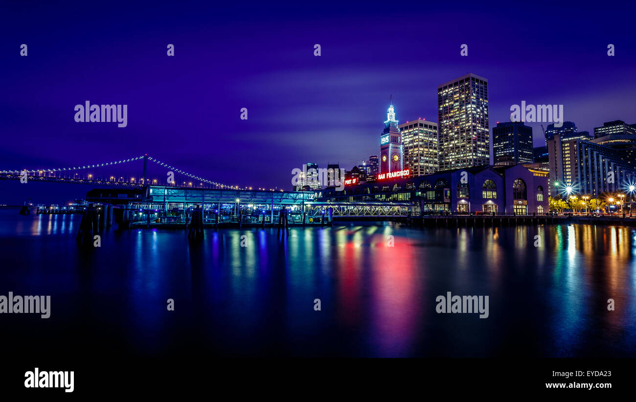 Ferry Building and Bay Bridge illuminated at night in San Francisco, California, USA Stock Photo