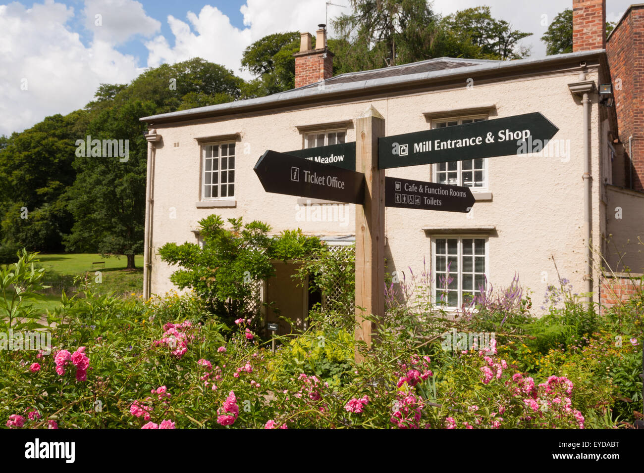 Gardens in Quarry Bank Mill, Cheshire UK, showing the fingerpost signs for parts of the property. Stock Photo