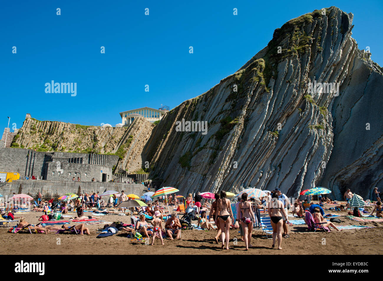 Sunbathing At Itzurun Beach, Zumaia, Basque Country, Spain Stock Photo