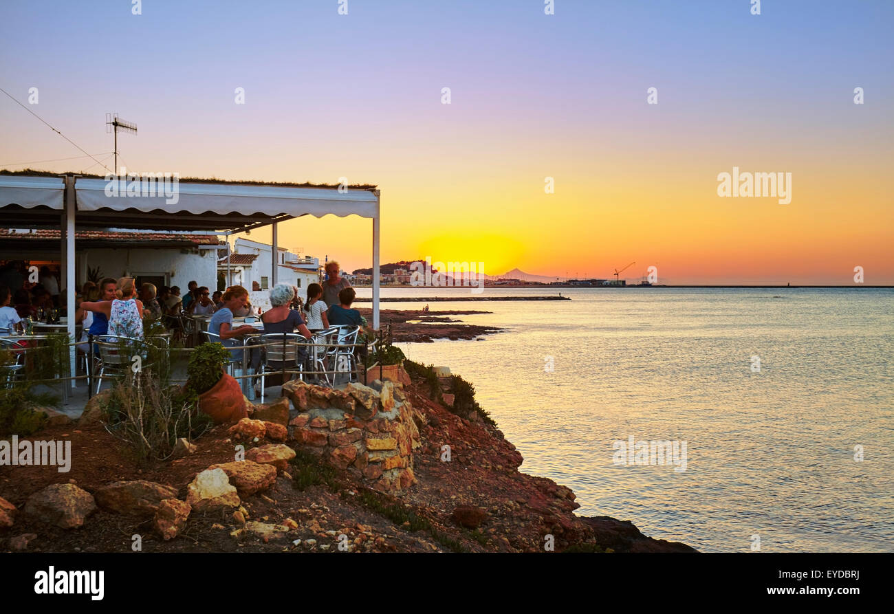 Beach bar by sunset at "Las Rotas" beach. Denia. Alicante. Valencia  Community. Spain Stock Photo - Alamy