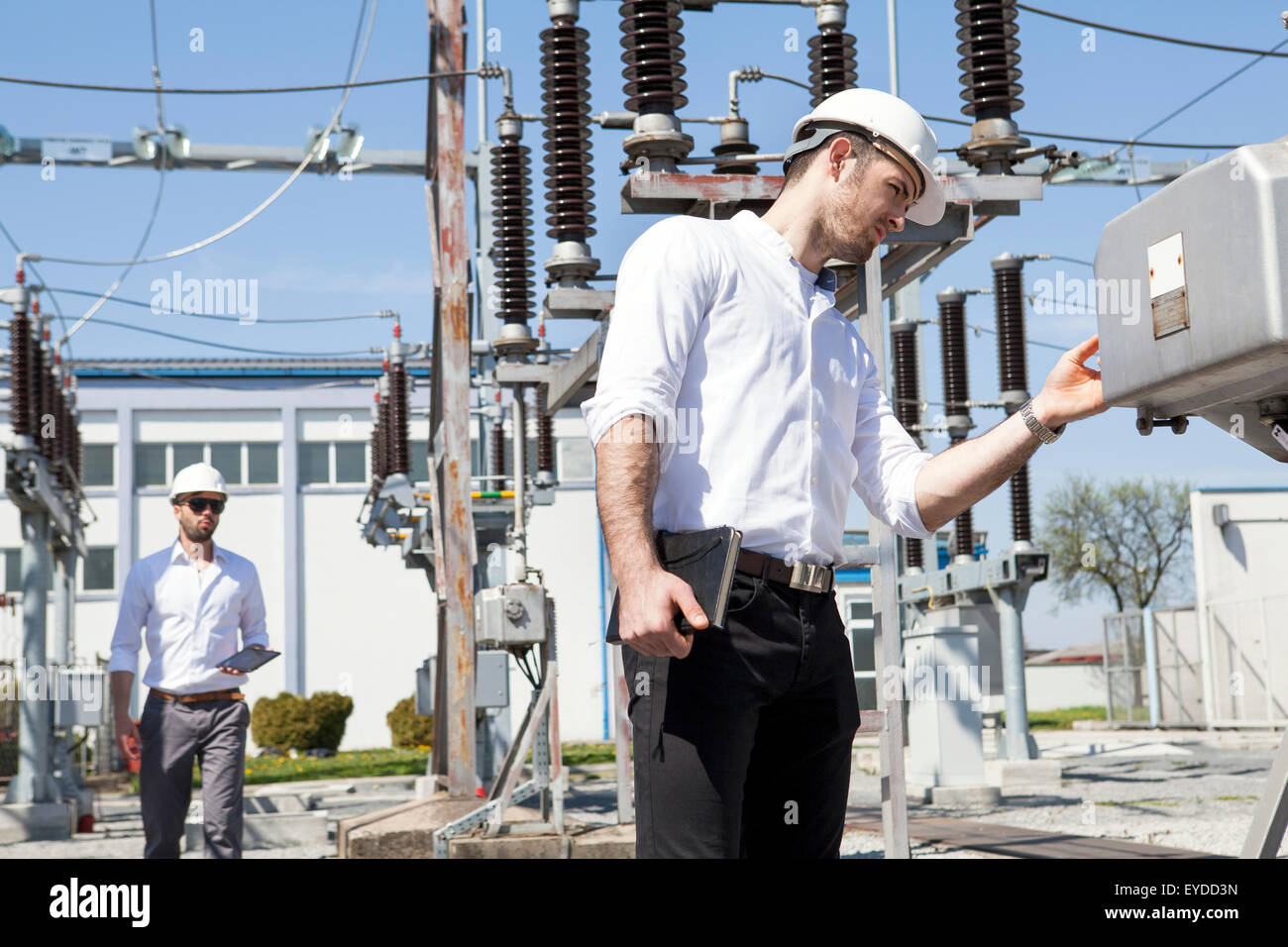 Engineers checking electricity substation Stock Photo - Alamy