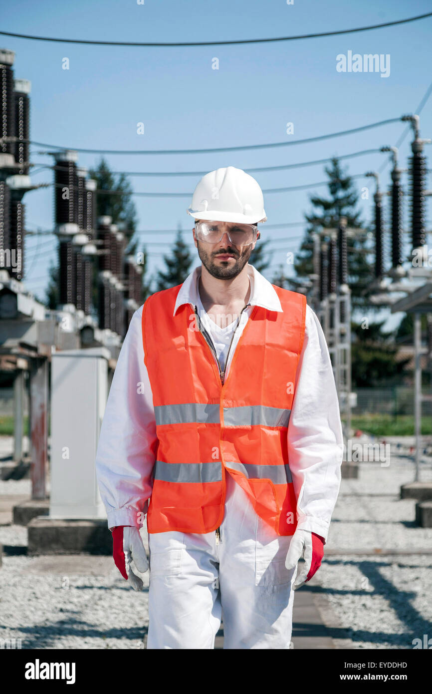 Portrait of engineer against electricity substation Stock Photo
