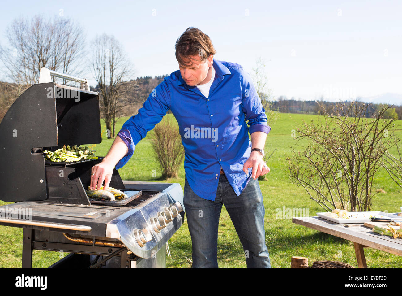 Man cooking barbecue in garden Stock Photo
