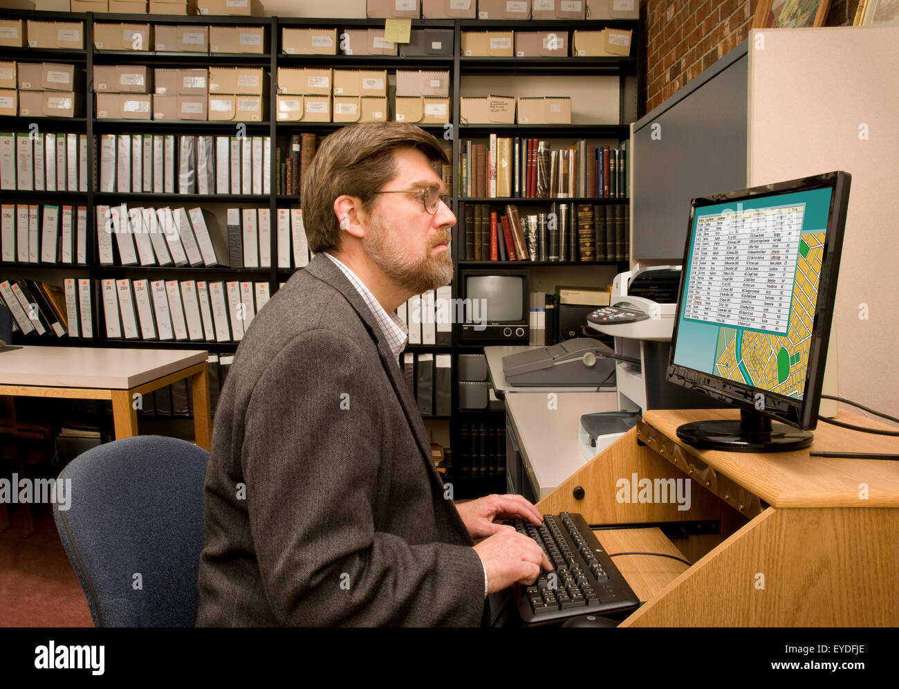 Researcher searching a computer database archives Stock Photo