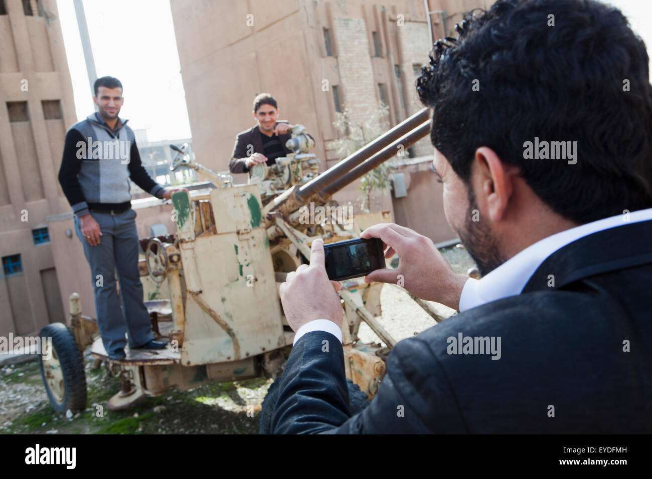 Men Photographing In Front Of The Amna Suraka (Red Security) Museum, Iraqi Kurdistan, Iraq Stock Photo