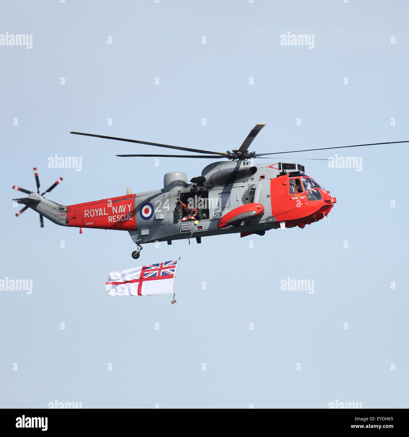 A Royal Navy Sea King HU5 helicopter performs at Sunderland International Airshow, England. The Sea King displays a white ensign Stock Photo
