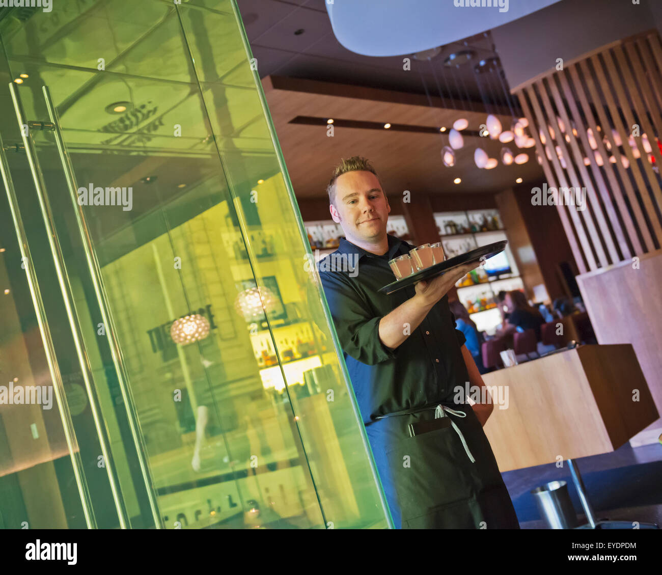 USA, Colorado, Waiter at Corner Office restaurant and Martini Bar
