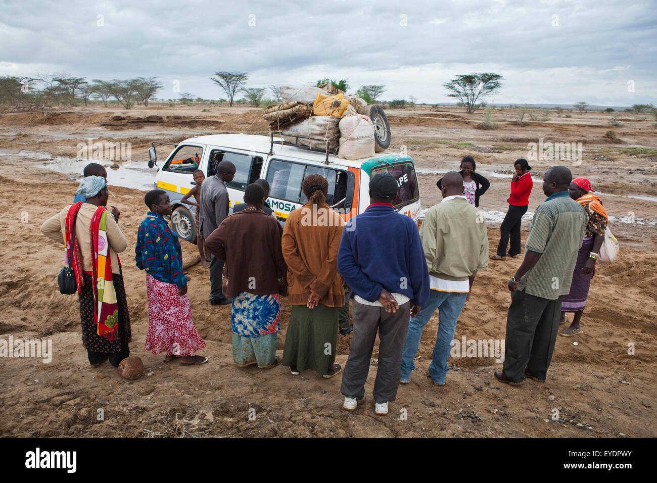 Kenya, View of people standing next to matatu (minibus taxi); North Turkana Stock Photo