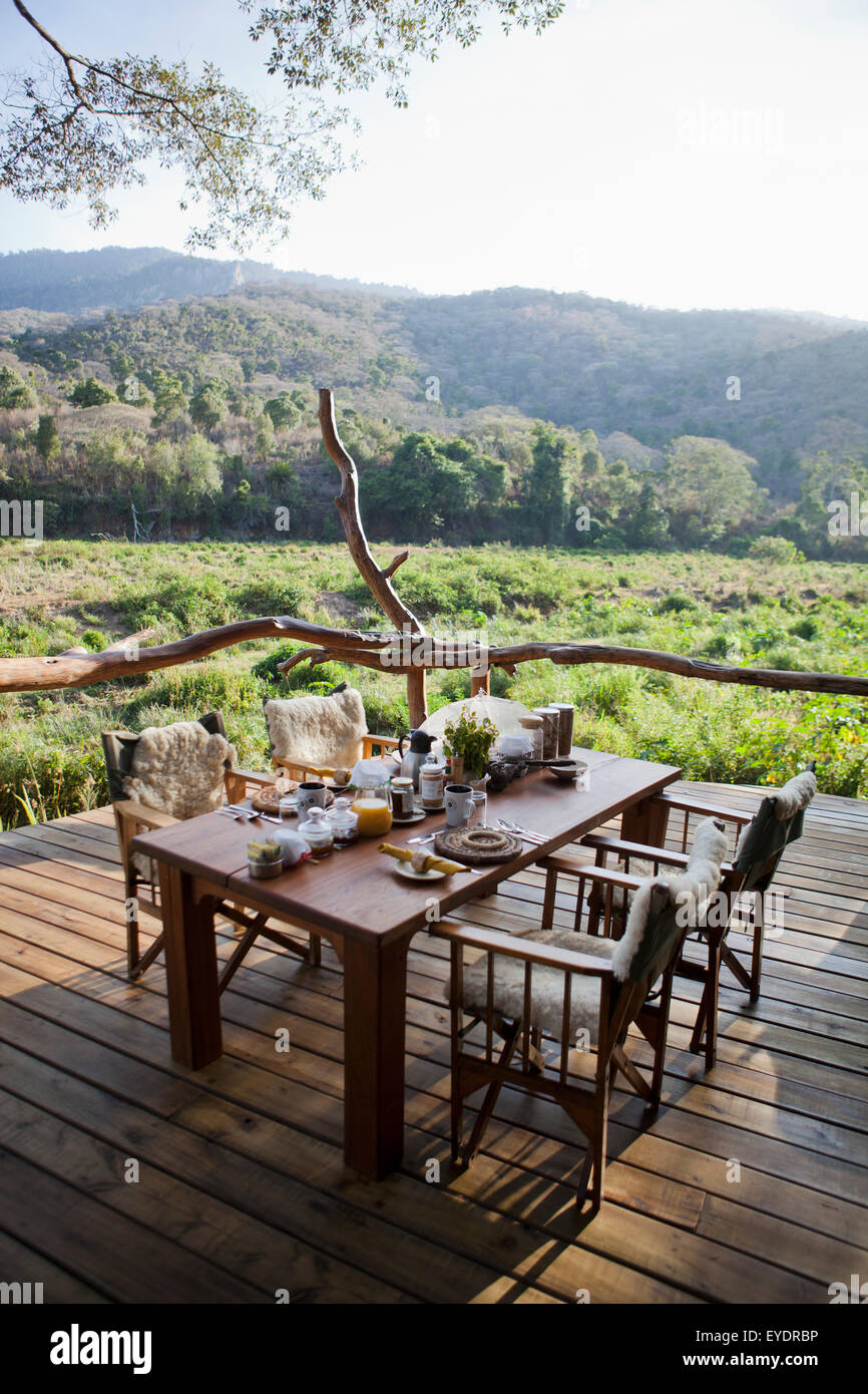Kenya, Breakfast table set up on porch at Kitich camp; Mathews Mountain Range Stock Photo