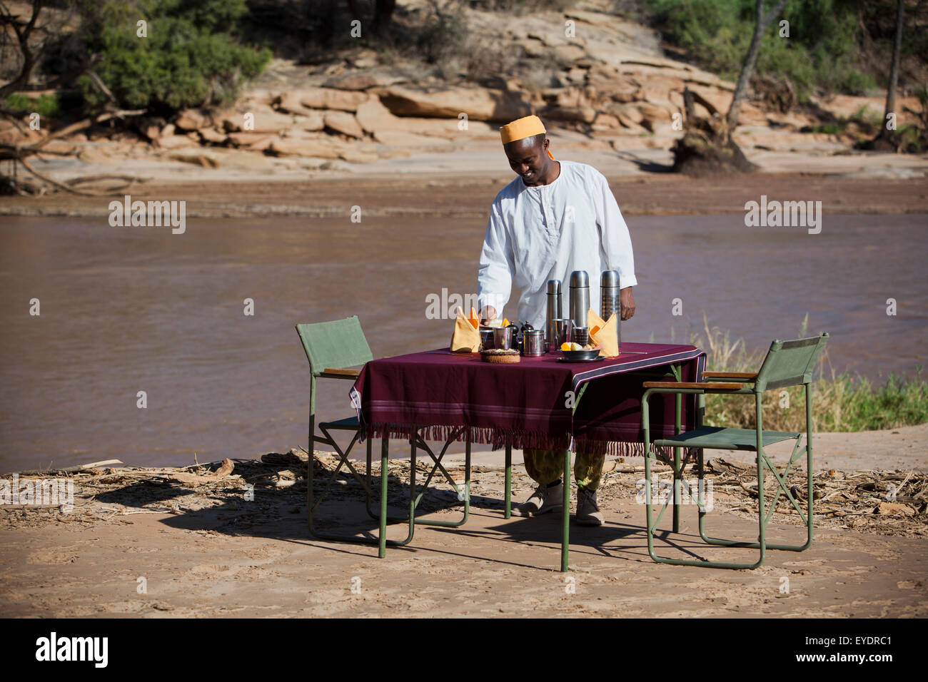 Kenya, Riverside breakfast table set up for guests at Joy's Camp; Shaba National Reserve Stock Photo