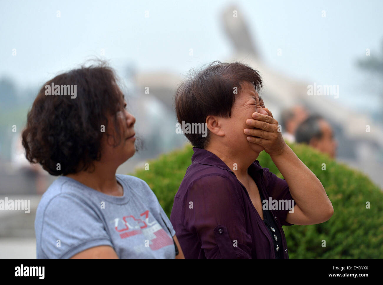 Tangshan, China's Hebei Province. 28th July, 2015. People mourn for relatives dead in the 1976 Tangshan earthquake in front of the memorial wall in Tangshan, north China's Hebei Province, July 28, 2015. Local residents came to the memorial park on Tuesday to commemorate the 39th anniversary of the Tangshan earthquake. Credit:  Zheng Yong/Xinhua/Alamy Live News Stock Photo