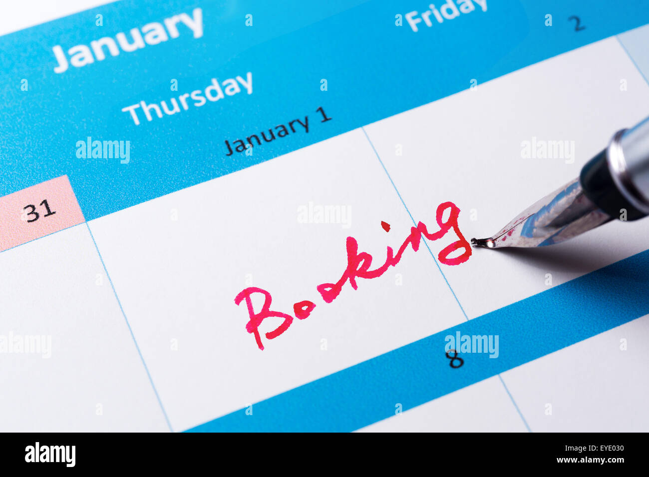 Booking word written on the calendar with a pen Stock Photo