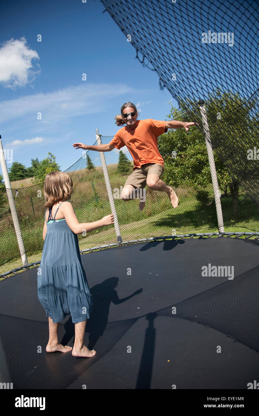 Two girls jumping on trampoline hi-res stock photography and images - Alamy