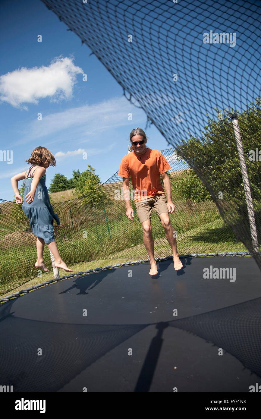 Two girls jumping on trampoline hi-res stock photography and images - Alamy