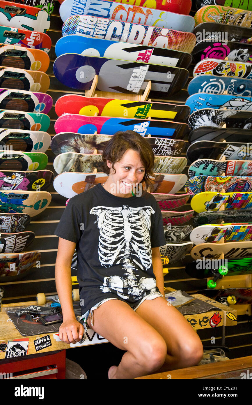 Usa, Rhode Island, Young Woman In Skateboard Shop; Newport Stock Photo