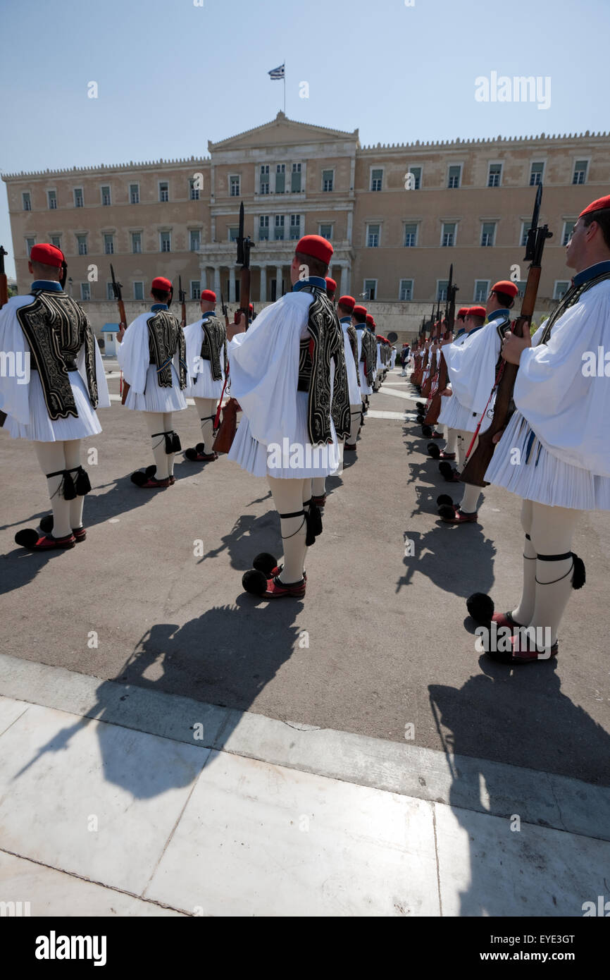 Evzoni infantry presenting arms during a ceremonial event attended by tourist crowds opposite Parliament site, Syntagma, Greece. Stock Photo