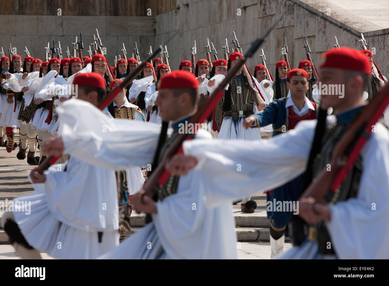 Infantry regiment of goose stepping Evzoni with shinning baggots/ bayonet rifle gun blades, after a ceremony . Athens, Greece Stock Photo