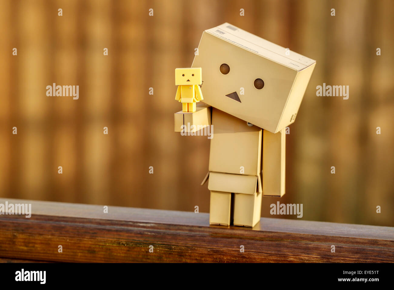 A Manga Japanese toy Danbo Danboard robot character posed for a portrait picture on a warm sunny morning. A large Danbo holding a tiny Danbo Stock Photo