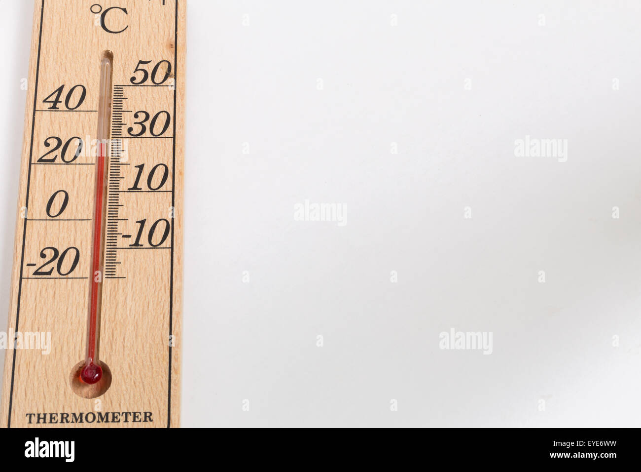 Thermometer made from wood on white background with 30 degree Celsius