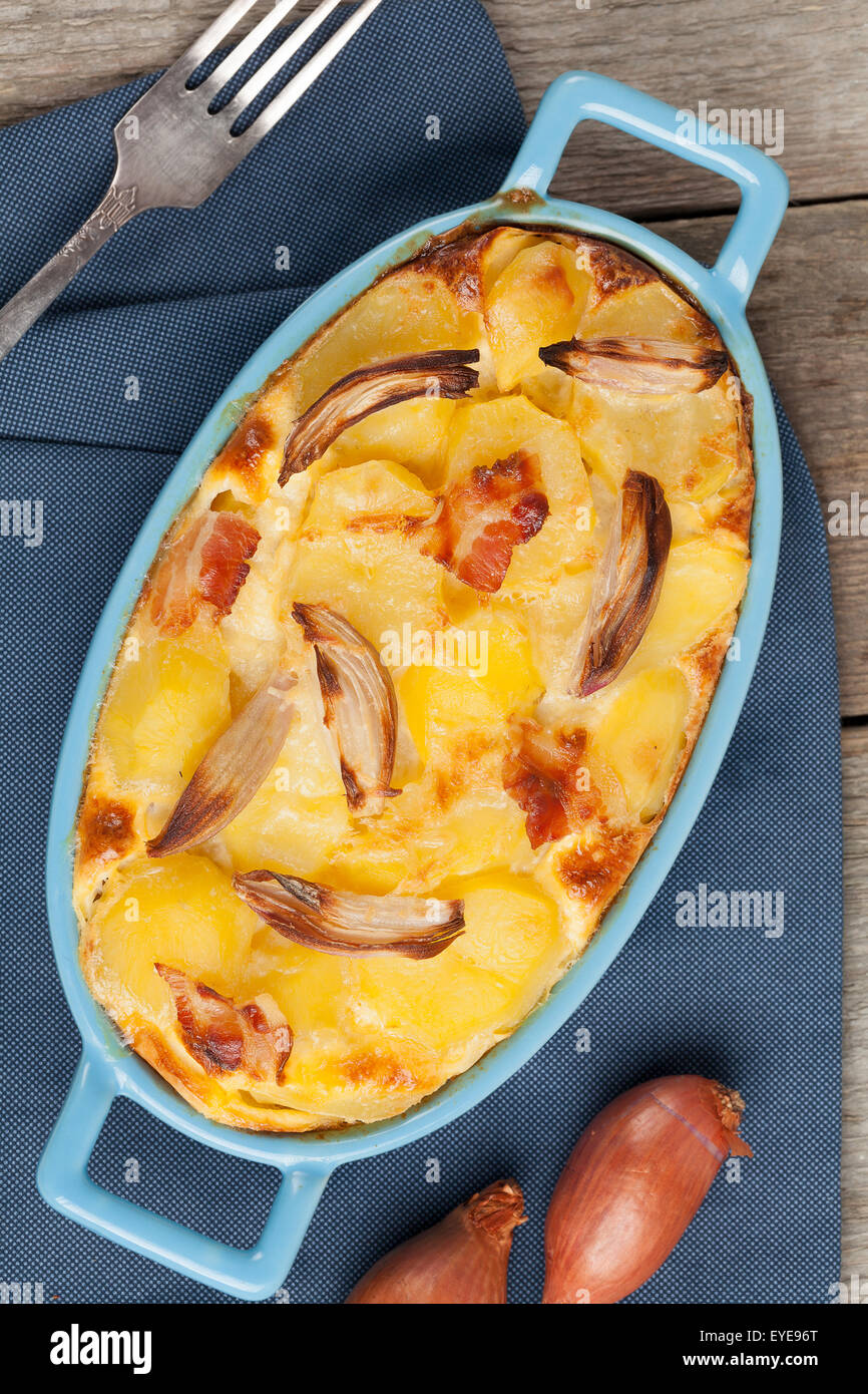 Potato casserole with onion, bacon and parmesan cheese. Stock Photo
