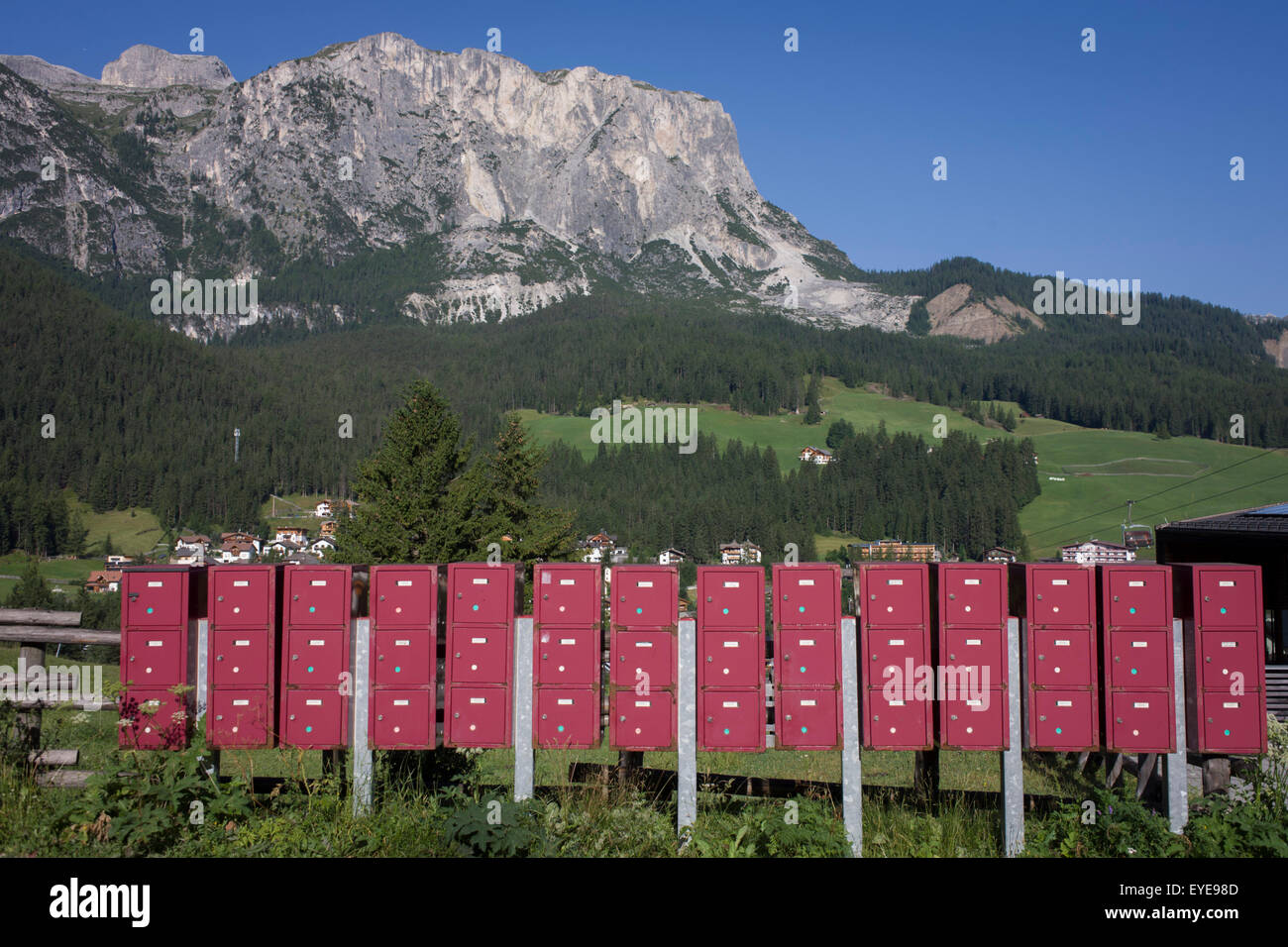 Pink post boxes outside a village school in Leonhard-St Leonardo, a Dolomites village in south Tyrol, Italy. Stock Photo