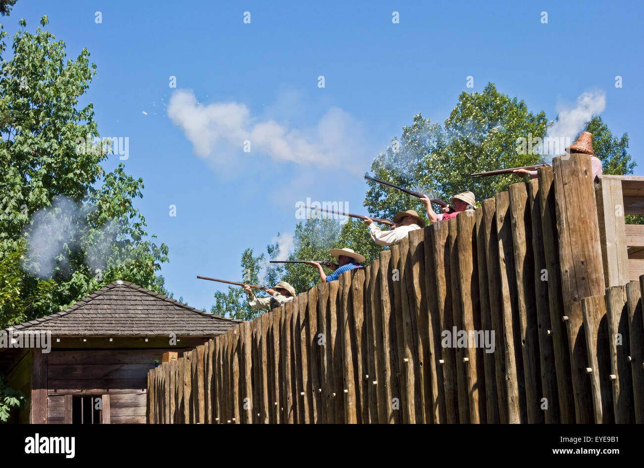 Muskets being fired off the walls of the Fort in a Canada Day display at Fort Langley National Historic Site in Fort Langley BC Stock Photo