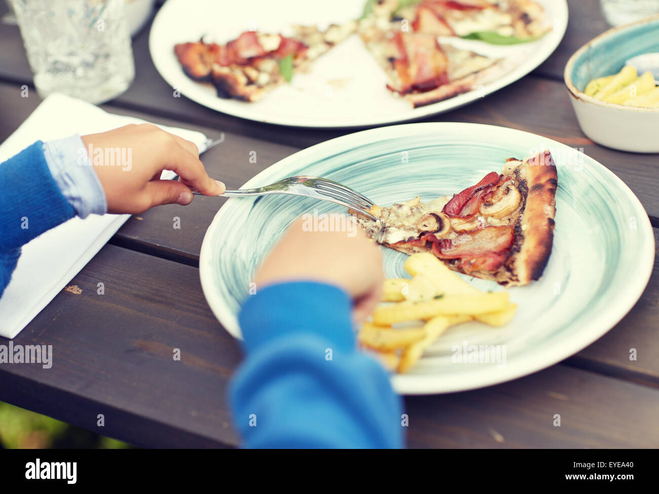 Child eating restaurant fork hi-res stock photography and images - Alamy