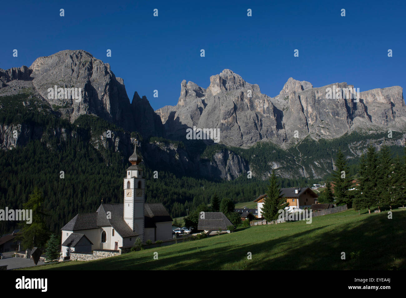 The church at Colfosco surrounded by Dolomites mountains, south Tyrol, Italy. Stock Photo