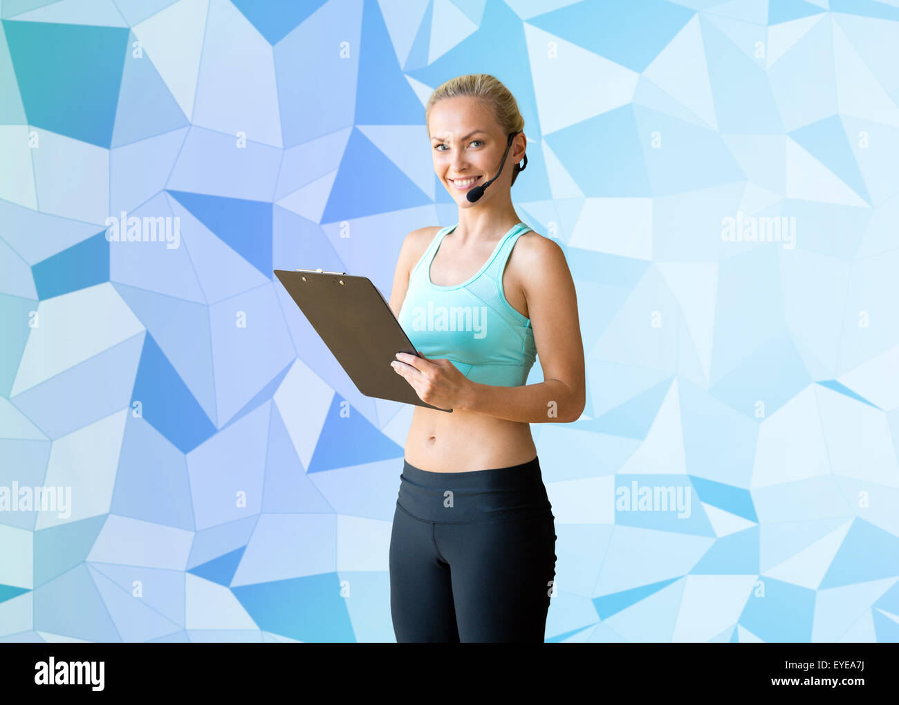 happy woman trainer with microphone and clipboard Stock Photo