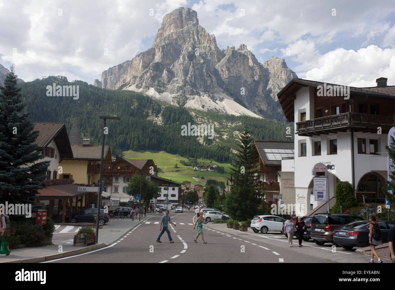 Mount Sassongher (2,665m) in the background of the the Dolomites resort town of Corvara during the summer walking season. Stock Photo