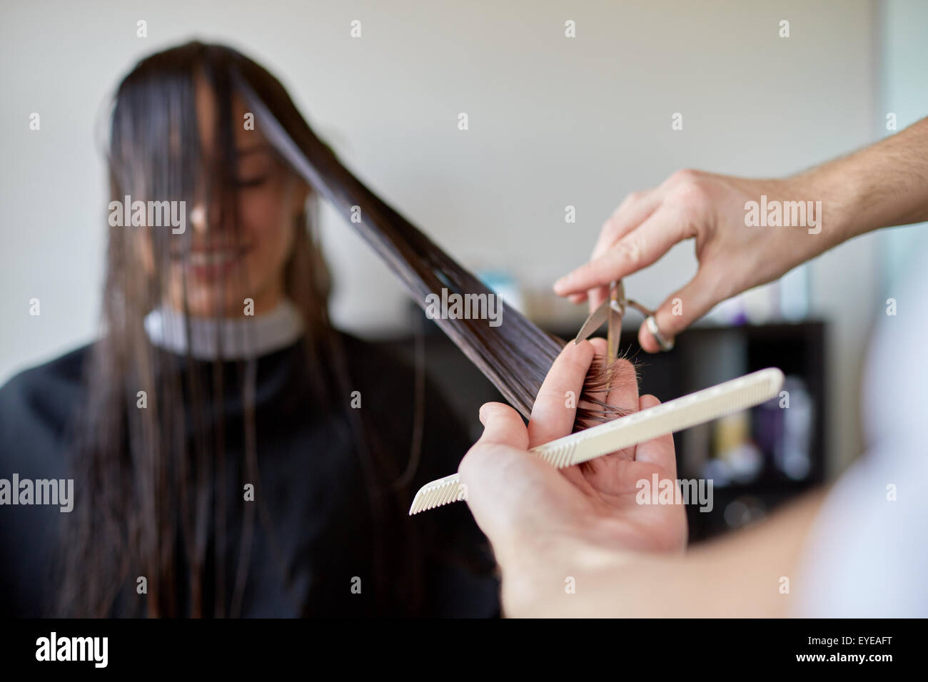 happy woman with stylist cutting hair at salon Stock Photo Alamy