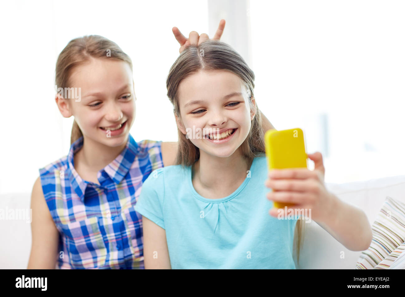 happy girls with smartphone taking selfie at home Stock Photo - Alamy