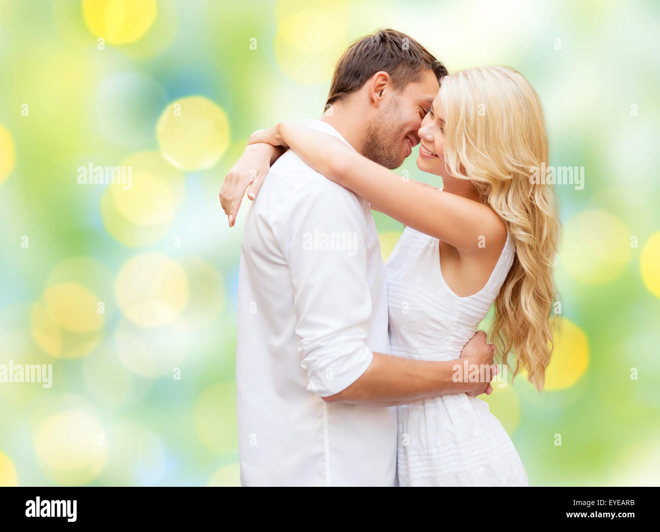 happy couple hugging over green lights background Stock Photo - Alamy