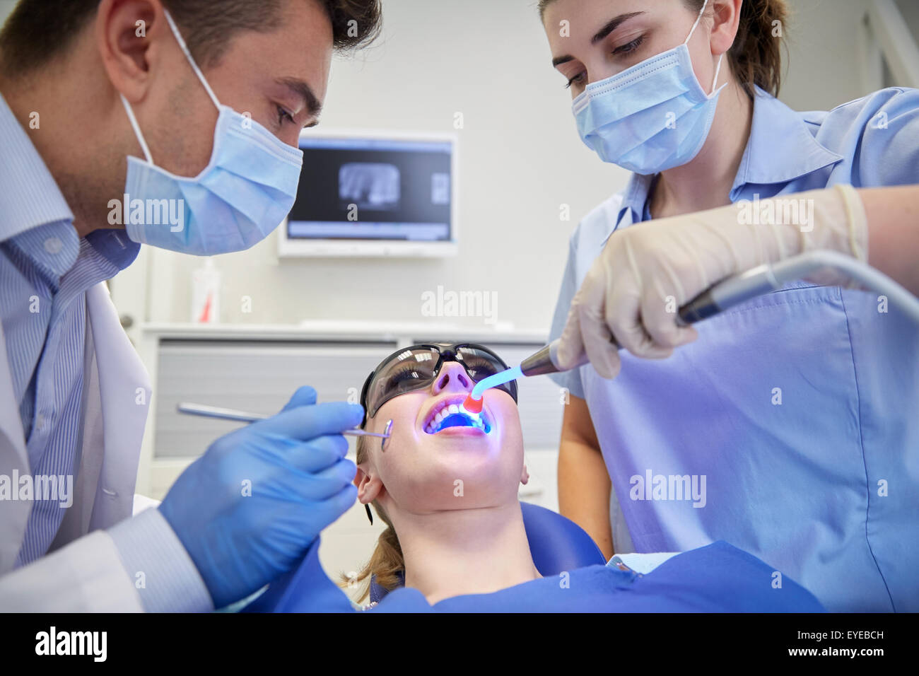 dentists treating woman patient teeth at clinic Stock Photo Alamy