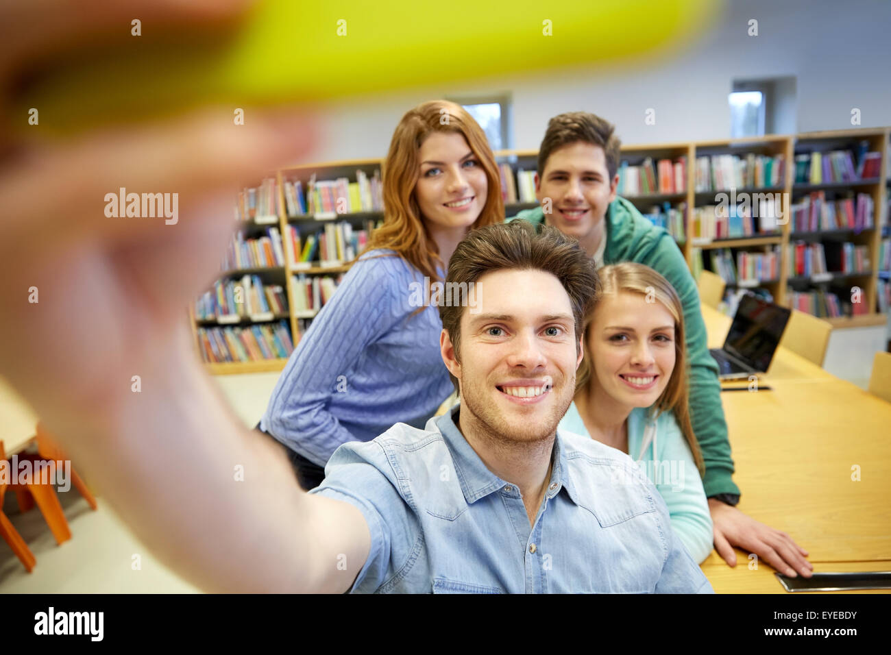 students with smartphone taking selfie in library Stock Photo Alamy