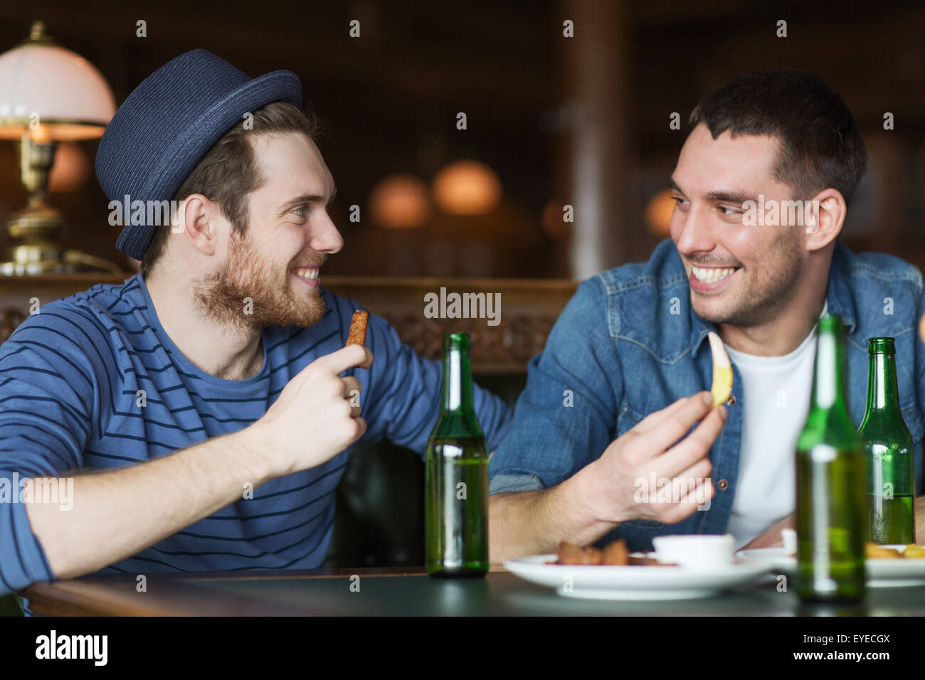 happy male friends drinking beer at bar or pub Stock Photo