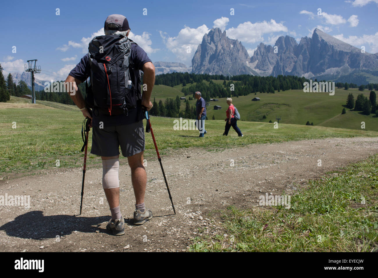 Hikers on the Siusi plateau, above the South Tyrolean town of Ortisei-Sankt Ulrich in the Dolomites, Italy. Stock Photo
