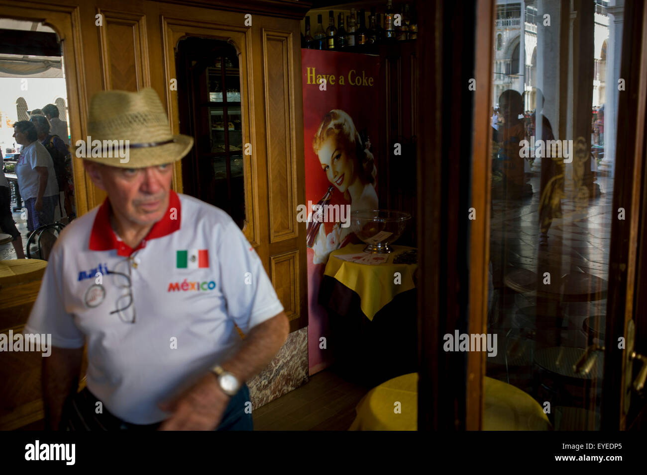 Tourist in cafe entrance inside the covered Procuratie Nuovo in Piazza San Marco, Venice, Italy. Stock Photo